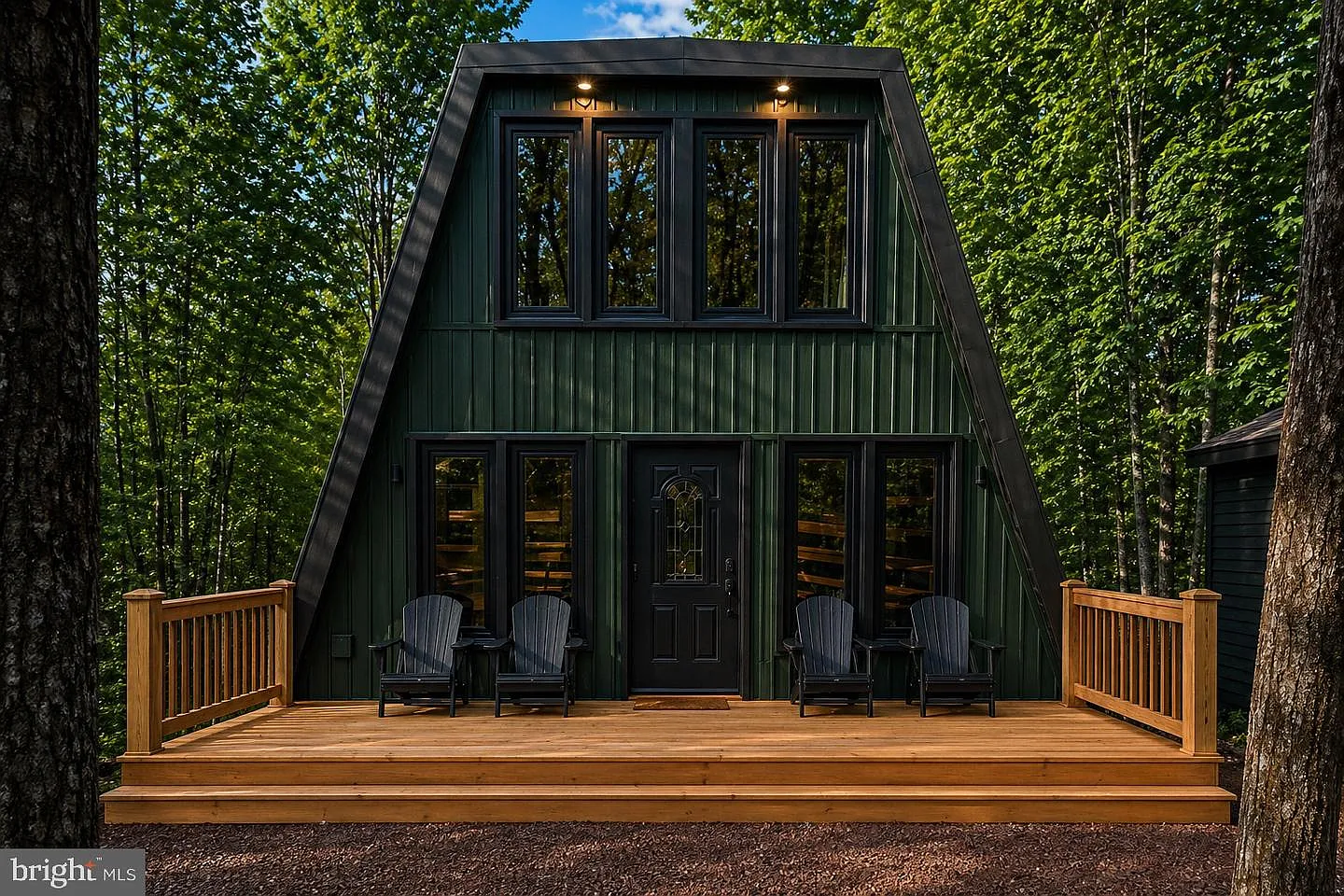 Mid-century modern A-frame chalet with deck surrounded by Pocono forest