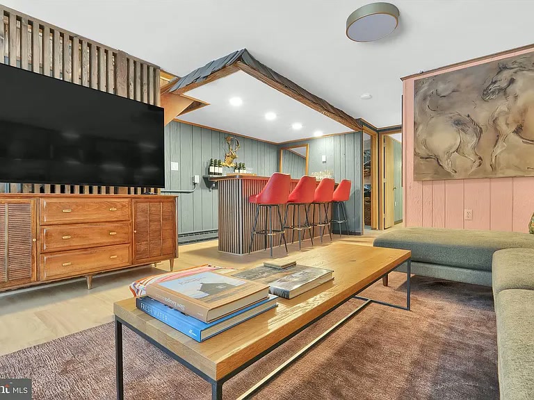Lower level TV den with bar, built-in bookshelf and sliding doors to the backyard
