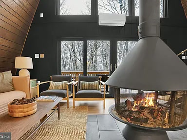 Carousel fireplace with firewood storage and sliding doors to the deck