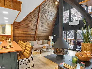 Great room with soaring wood ceiling and suspended fireplace