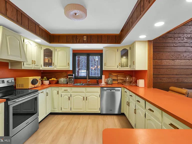 Eat-in kitchen with black walnut dining table and retro accents